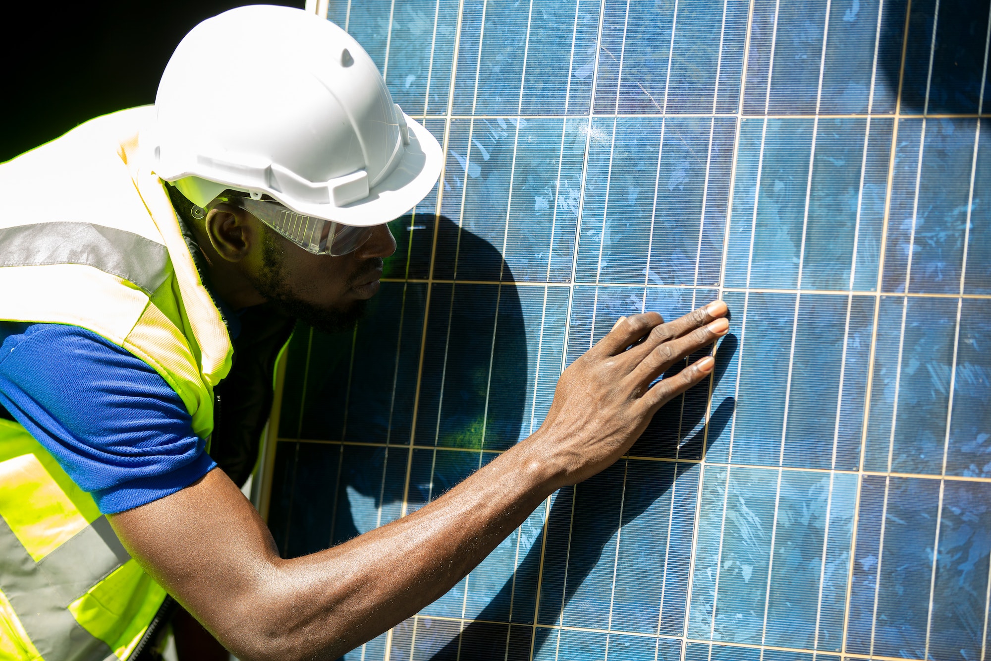 african american worker working on solar cell installation at sit